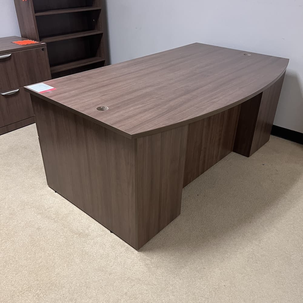 walnut laminate bow front desk with double pedestal silver pulls. Used office furniture