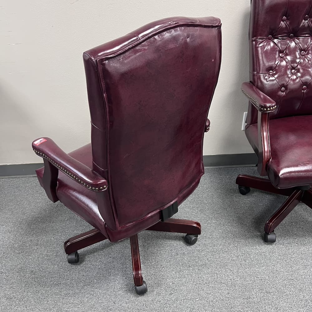 burgundy vinyl executive chair with high back and cherry 5 star base and arms details, used office furniture