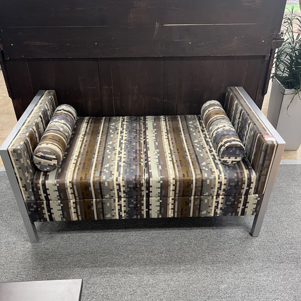 brown and copper and silver upholstered bench with metal sides, square patter with round cylindrical pillows, Paoli brand, commercial furniture, used office furniture, lounge reception area