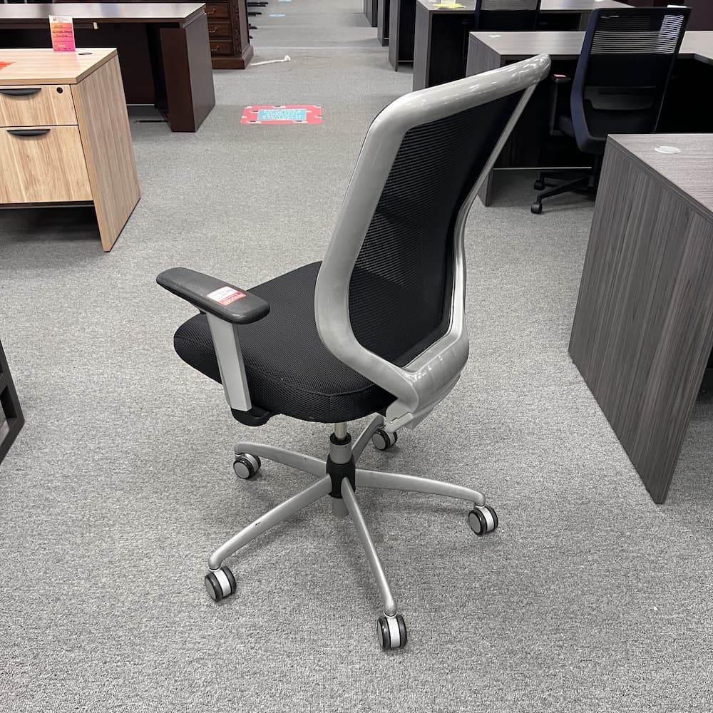 black mesh back task chair with upholstered seat, silver framing and base, used office furniture