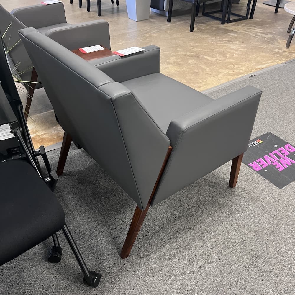 grey vinyl lounge chair with walnut veneer details, used office furniture, reception area