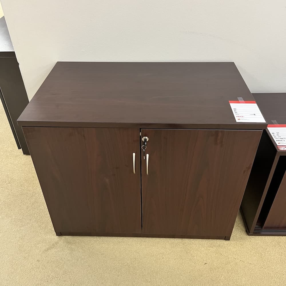mahogany laminate 2 door storage cabinet with silver pulls, 29" tall, used office furniture