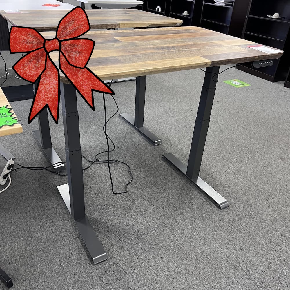 ribbon a woodgrain laminate vari desk top with a grey metal base, used office furniture, standing desk