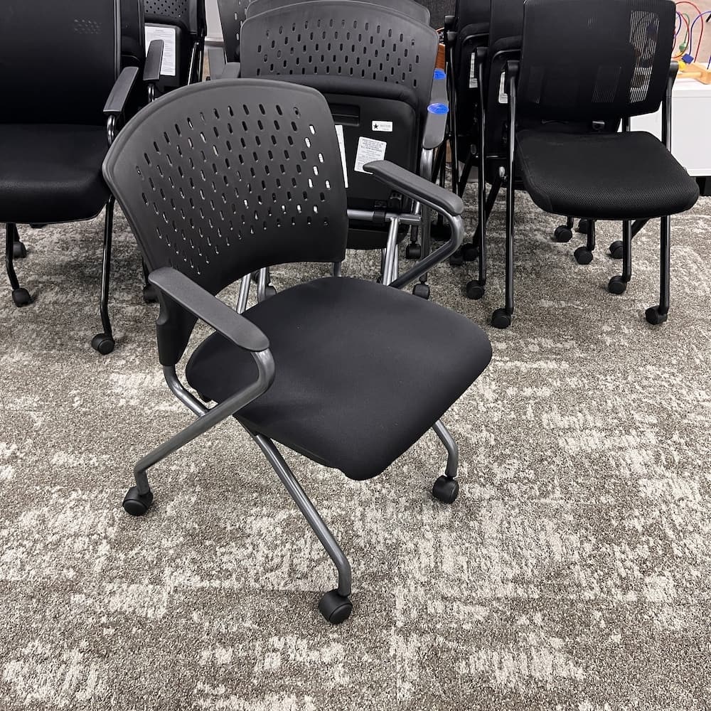 black upholstered seat and plastic perforated back, nesting chair, office chair, new