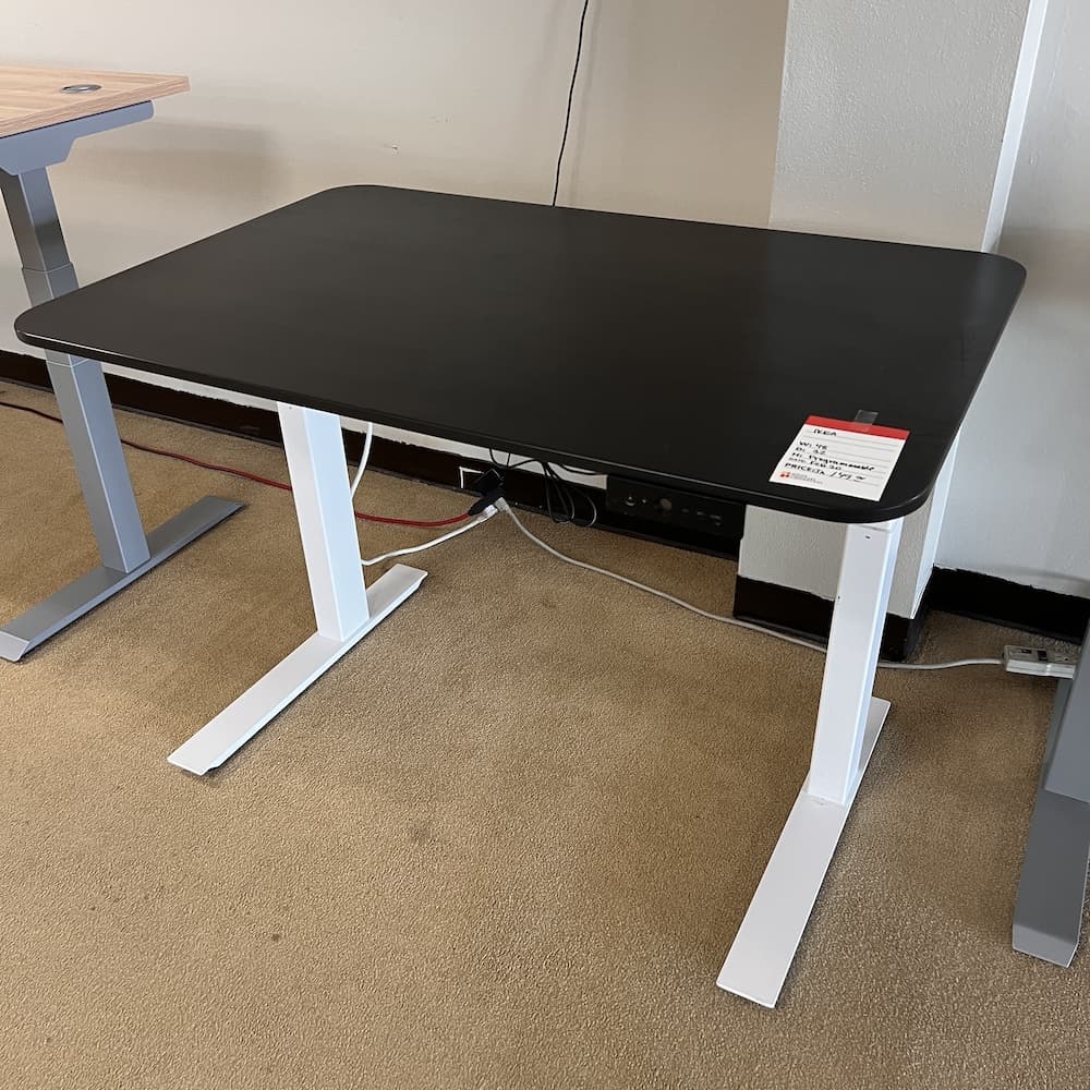 black ikea height adjustable standing desk with white legs, used office furniture