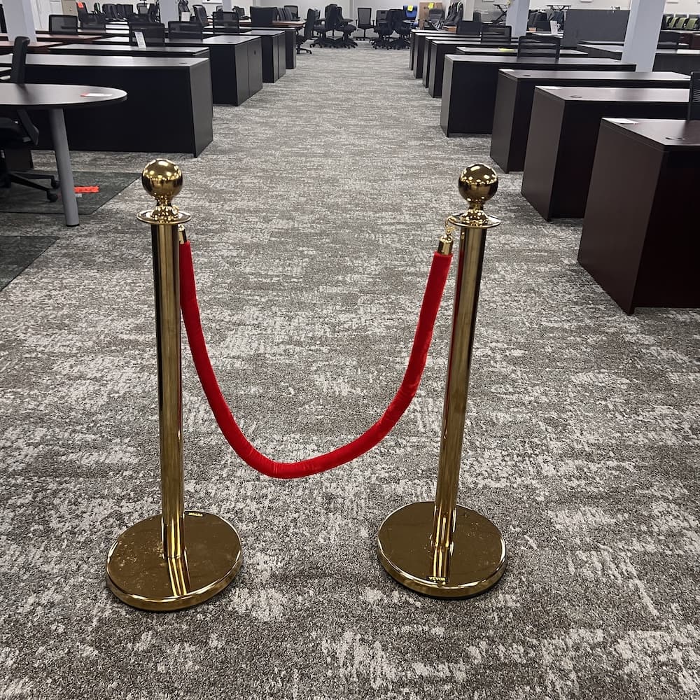2 gold stanchons with red velvet rope, used line queue control