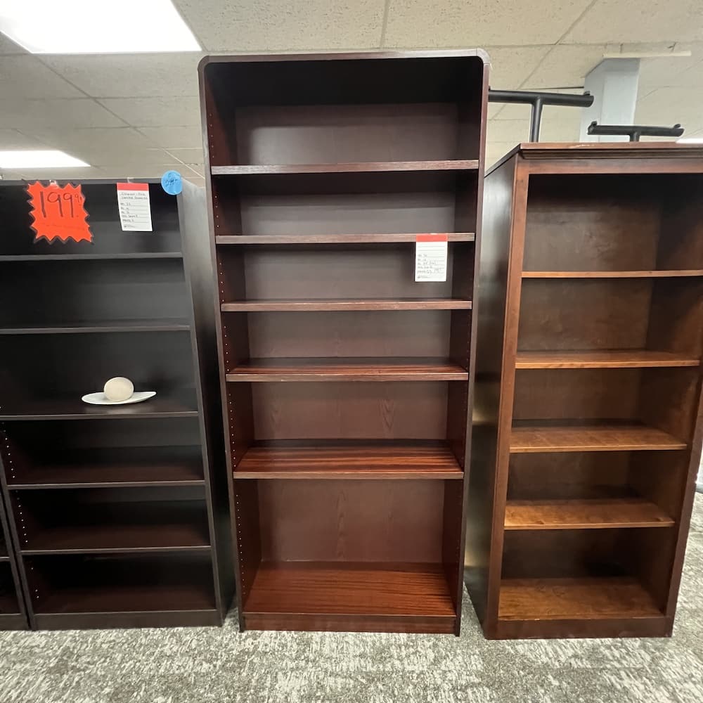 7 ft tall mahogany laminate bookcase with rounded top shoulders, used office furniture