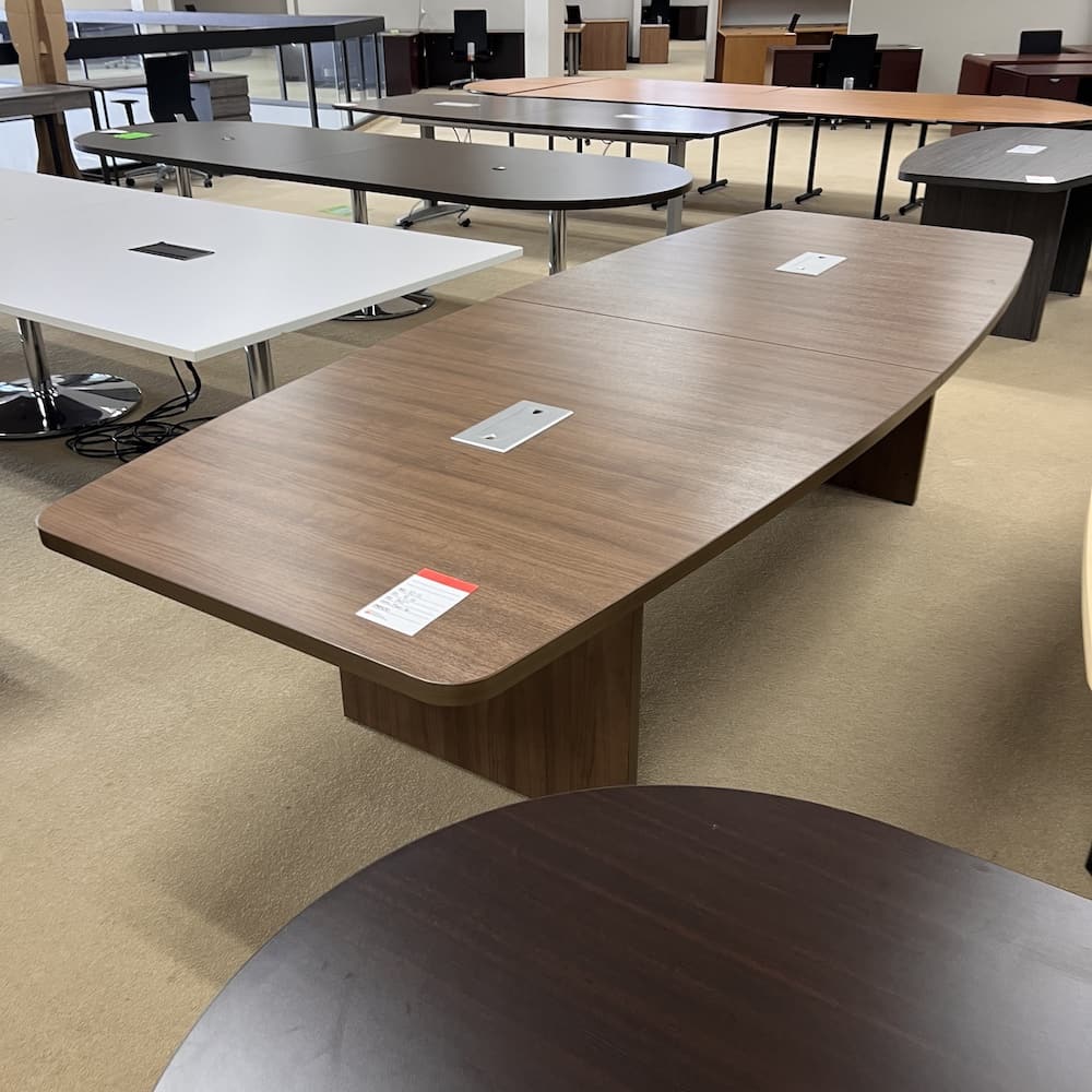 10 ft laminate boat shaped conference table, walnut with slab base, used open box office furniture