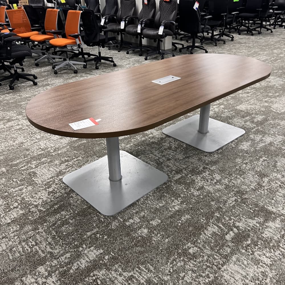 8 ft walnut laminate racetrack conference table with grey metal legs, used office furniture