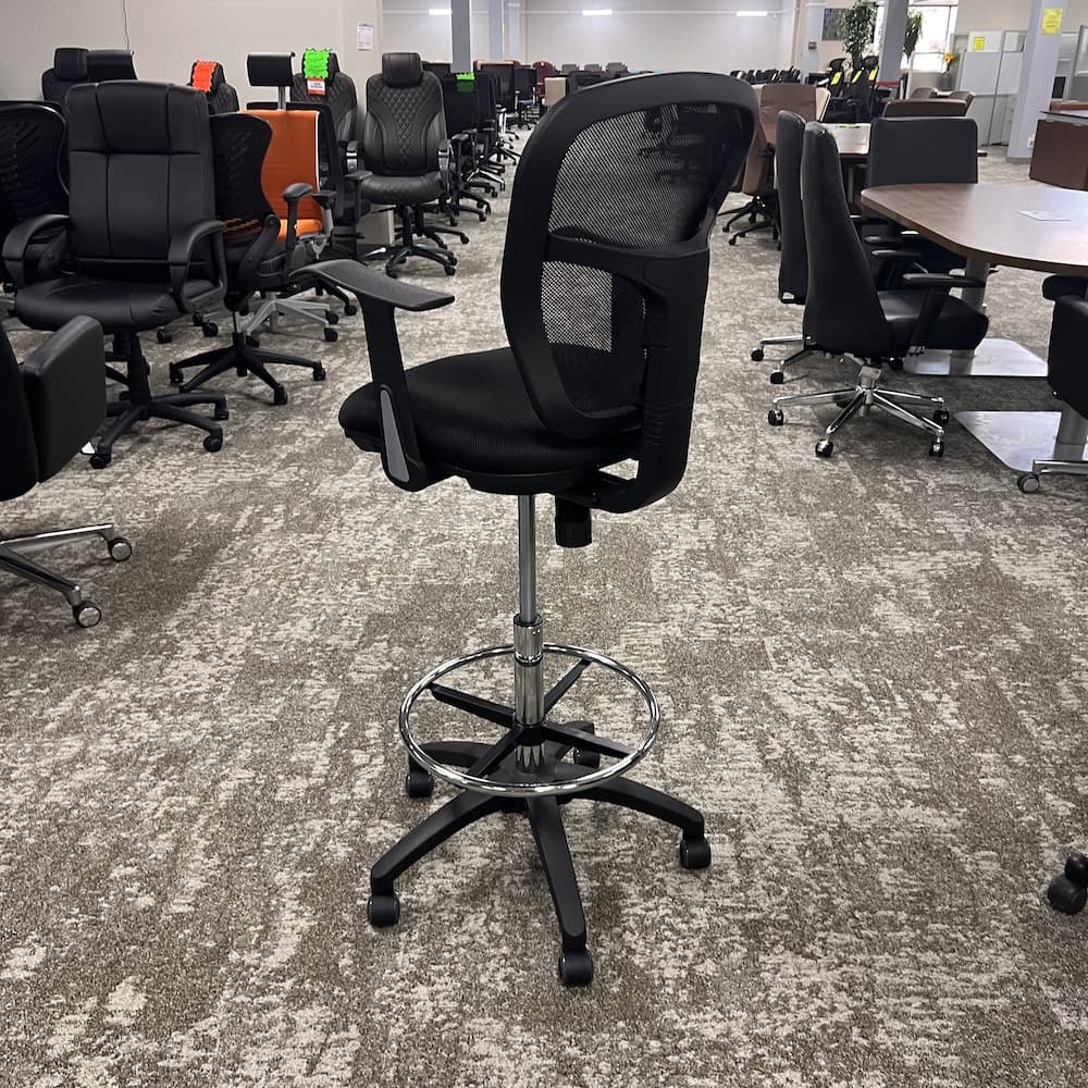 black upholstered seat and black mesh back new office stool, rolling with chrome foot rest.