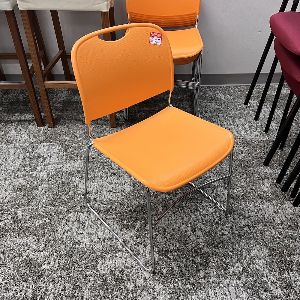 orange stacking plastic chair, used office furniture Lacasse 8400