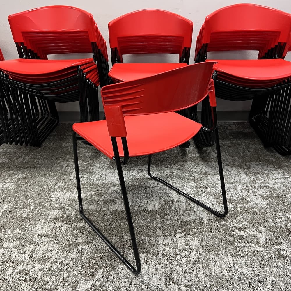 red plastic with black legs stacking chair, 1980's Paolo Favaretto assisa, used office furniture, designer goods, vintage look