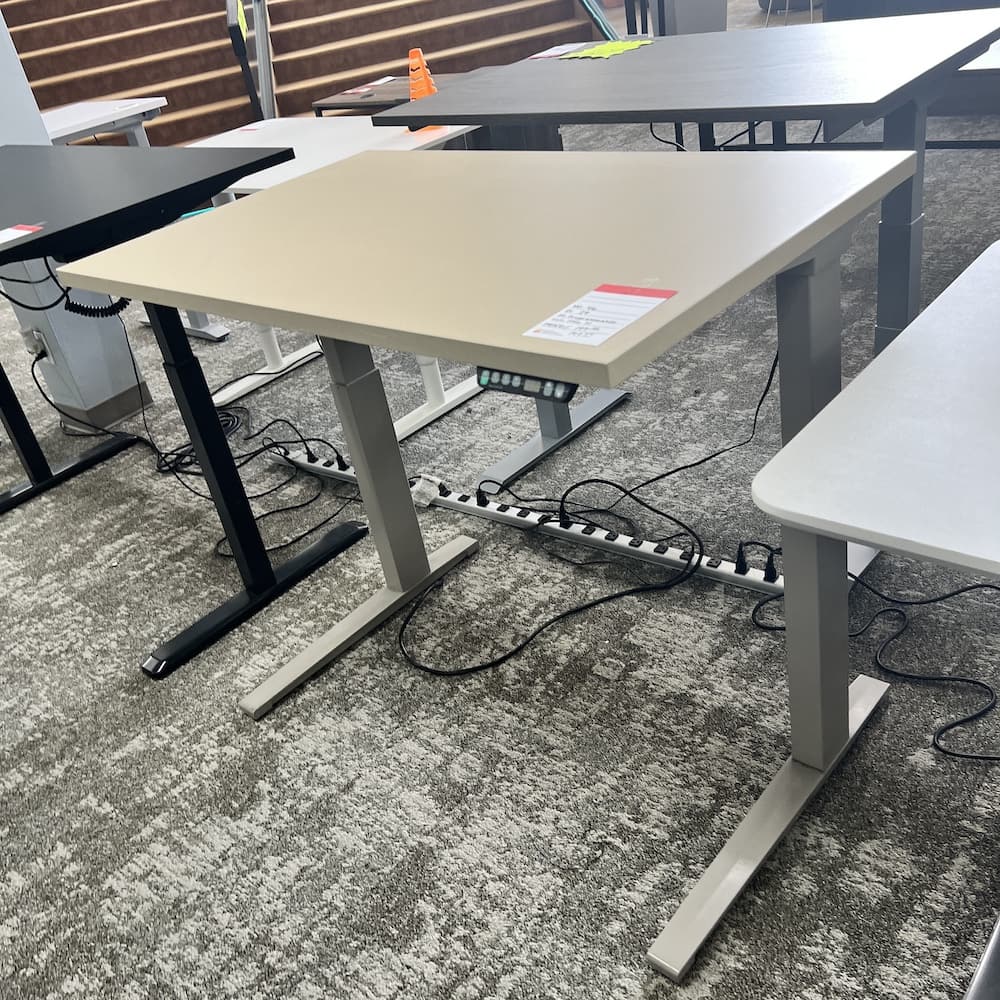 beige laminate height adjustable desk with trap egress metal base, used office furniture