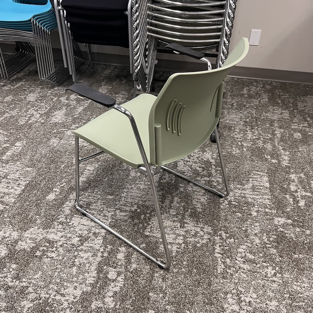 green sage plastic stacking chair with black arms and chrome base, open box office furniture