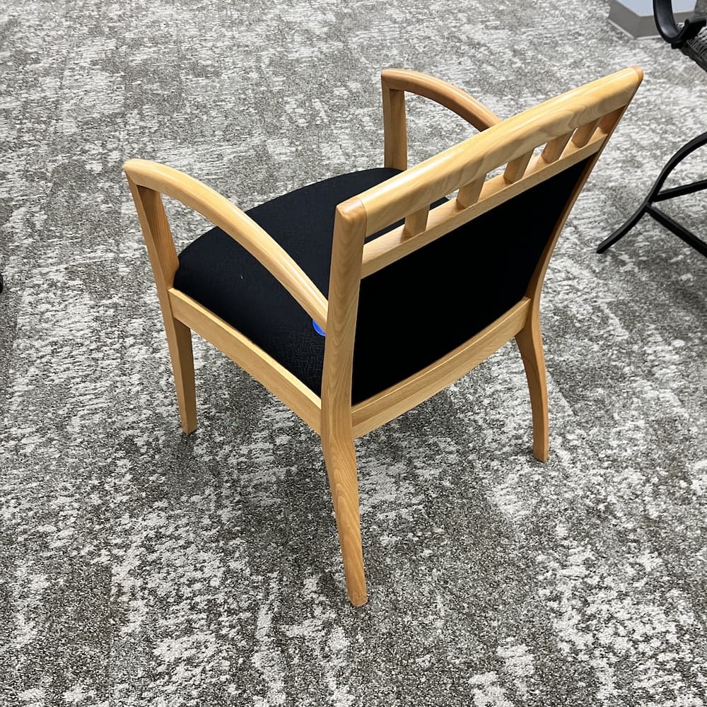 black upholstered guest chair with maple veneer frame. closeout office furniture
