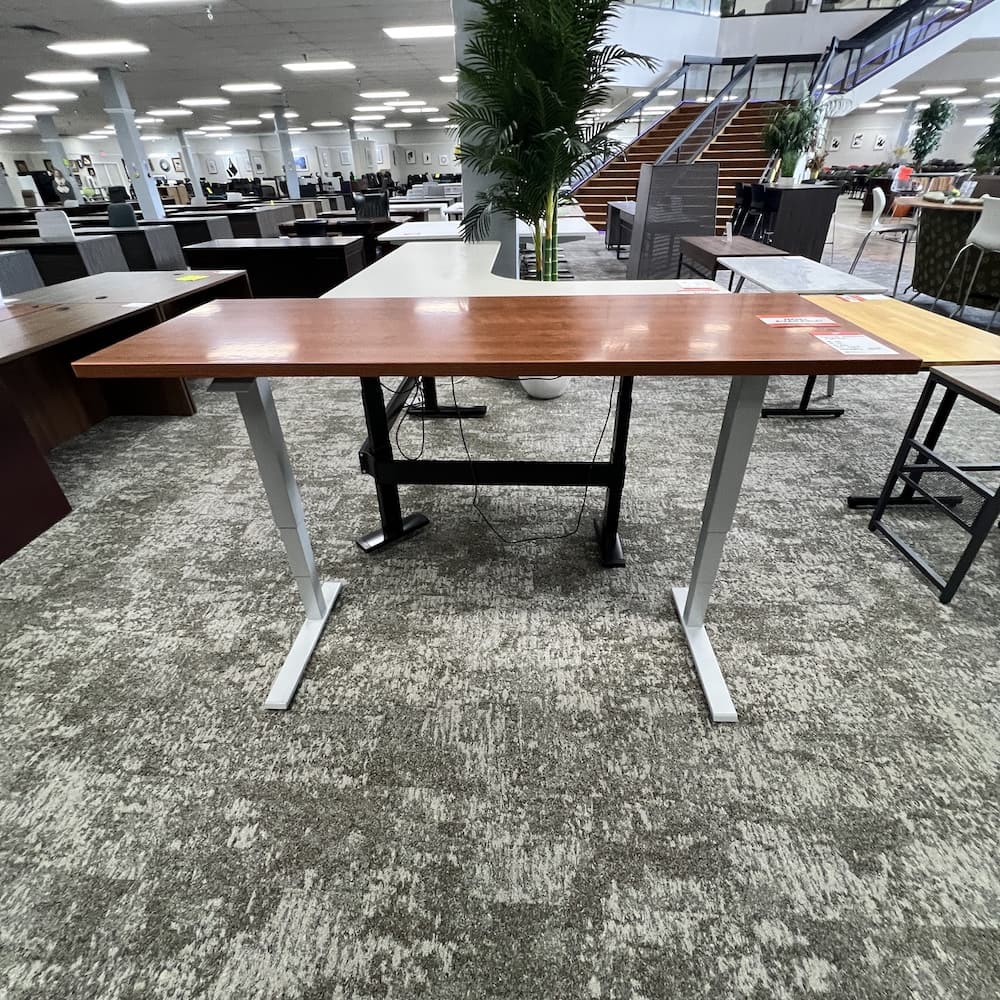 66 x 26 cherry laminate human scale hydraulic height adjustable desk with grey metal legs, used office furniture