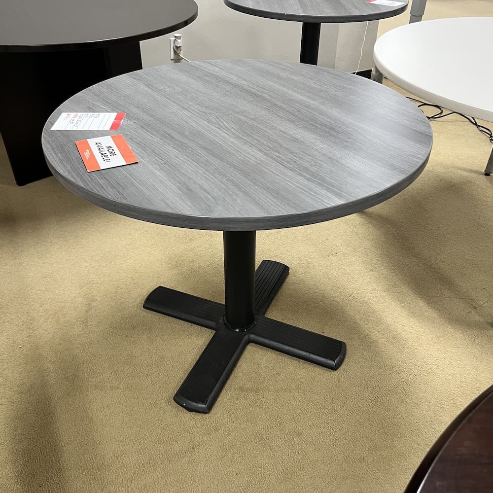 grey laminate round break room table with black metal base, used office furniture