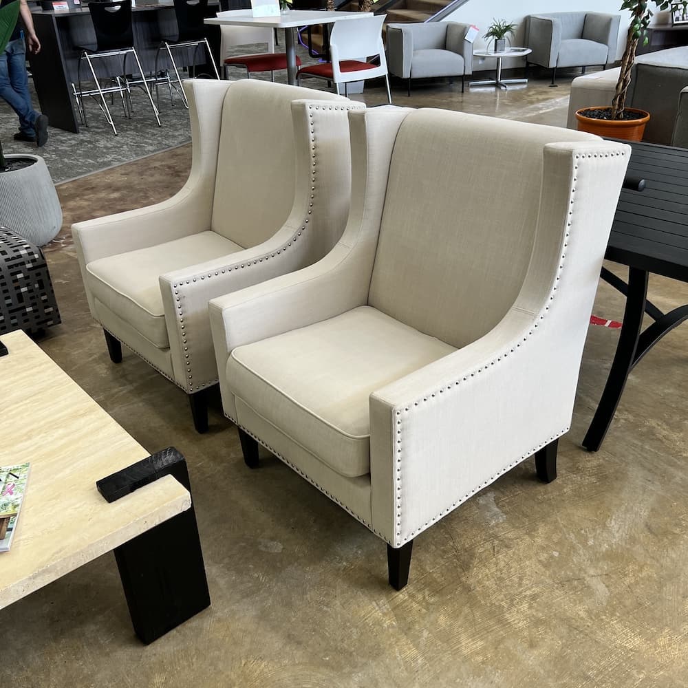 white beige upholstered wingback arm chairs