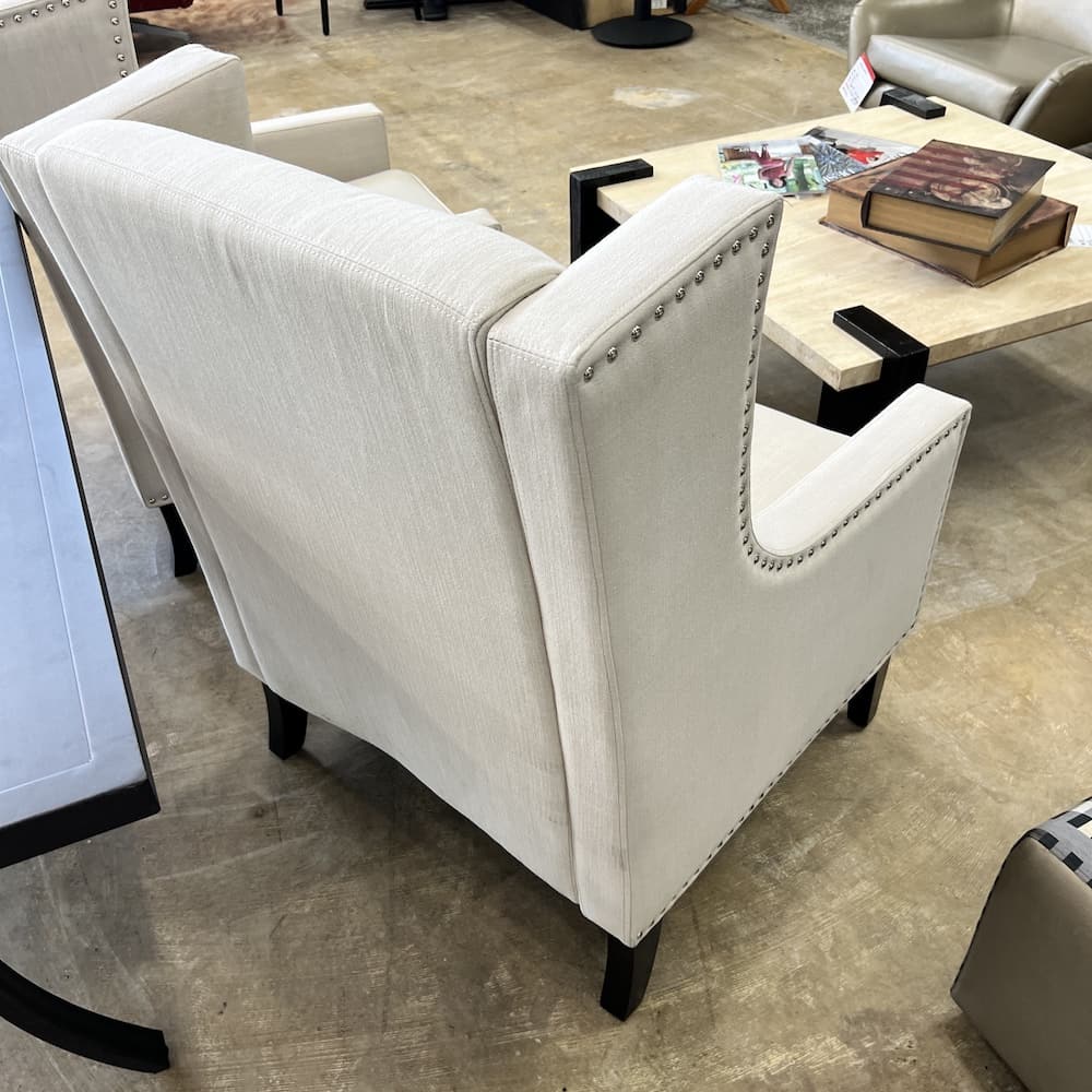 white beige upholstered wingback arm chairs