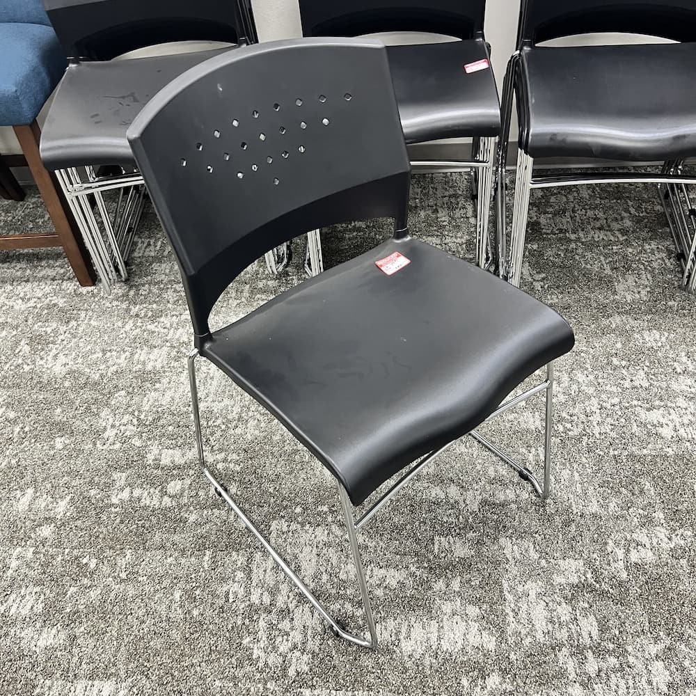 black plastic stacking chair, used office furniture