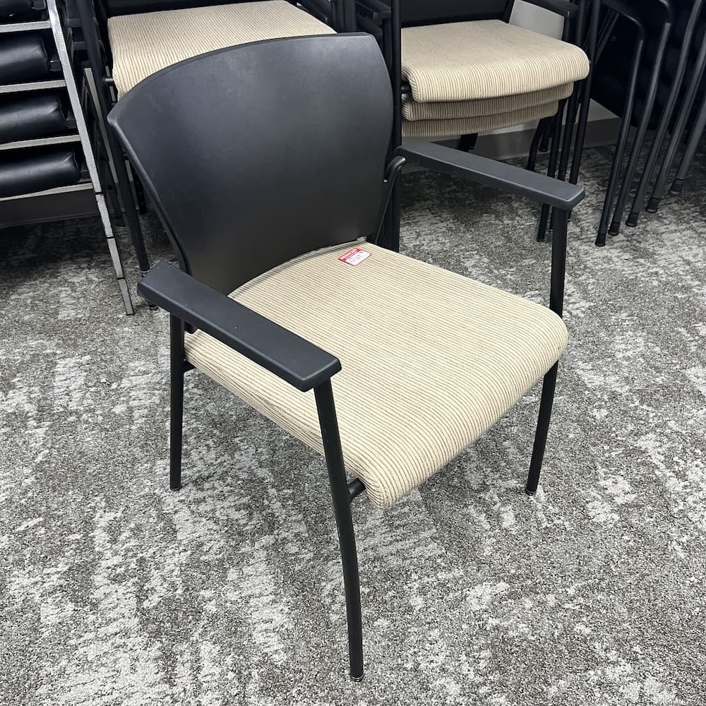 tan upholstered black stacking chair, teknion saver, used office furniture