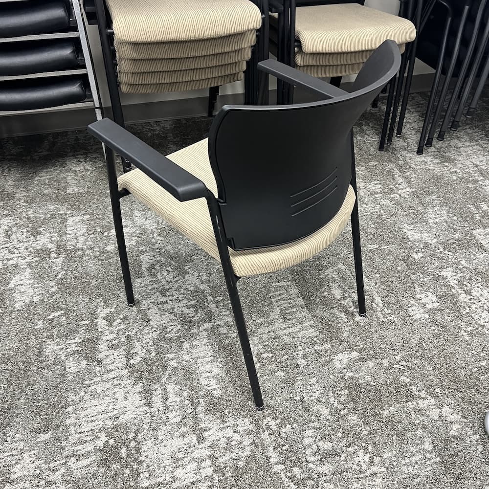 tan upholstered black stacking chair, teknion saver, used office furniture