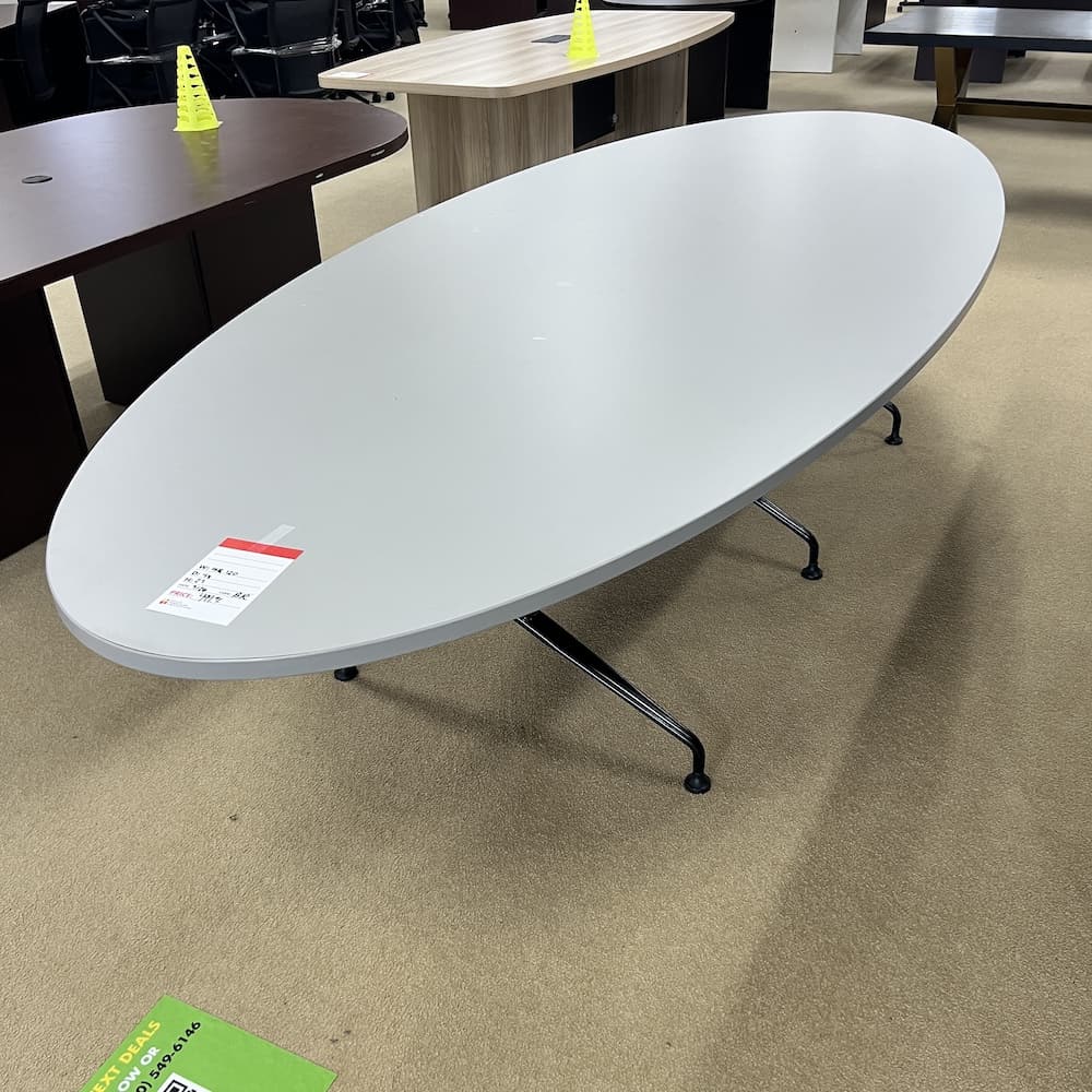 light grey laminate oval shaped conference table, 10 ft, black legs, used office furniture in San Antonio Texas
