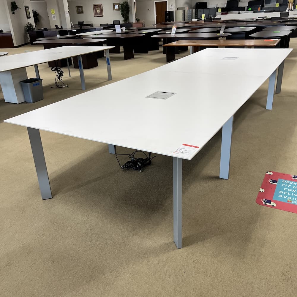 haworth white laminate 15 foot conference table, rectangle with silver legs, and 2 power hubs. Used office furniture